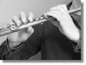 Image of a musician holding a flute, used to illustrate Houghton Hand Therapy's services offered to help prevention of and recovery from injuries to a musician's hands in the Doncaster, Retford and Worksop areas.