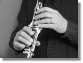 Image of a musician holding a clarinet, used to illustrate Houghton Hand Therapy's services offered to help prevention of and recovery from injuries to a musician's hands in the Doncaster, Retford and Worksop areas.